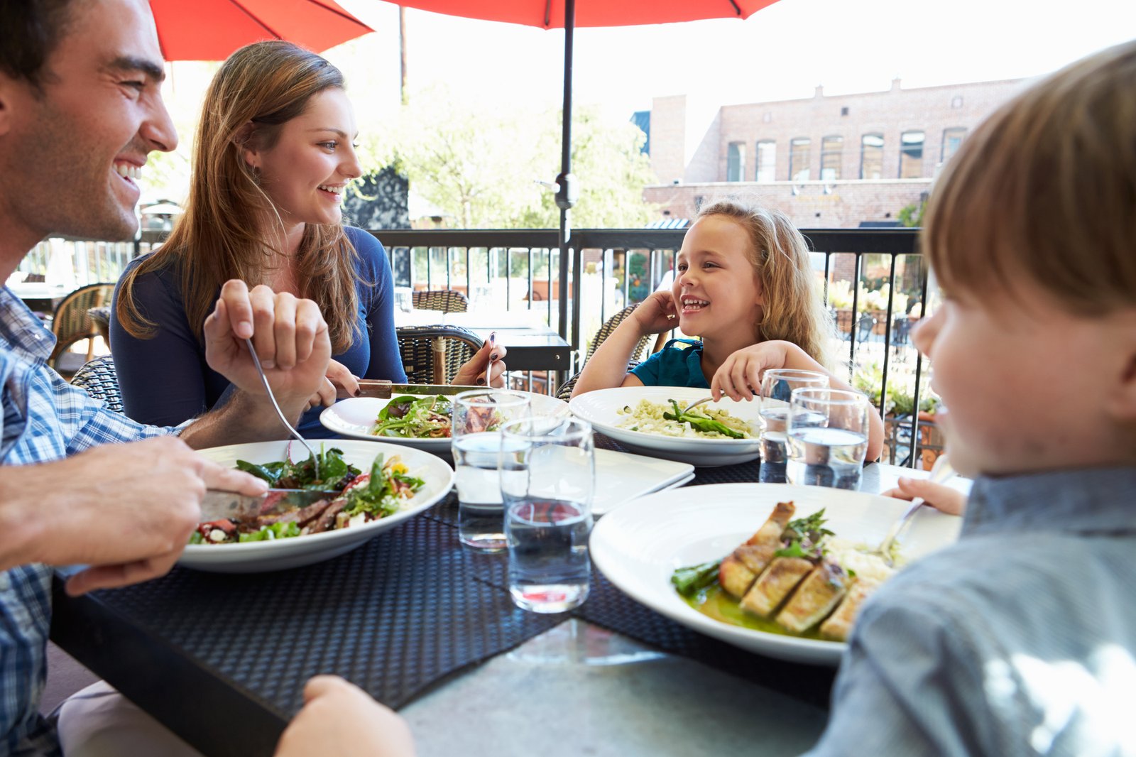 Family Enjoying Meal At Outdoor Restaurant